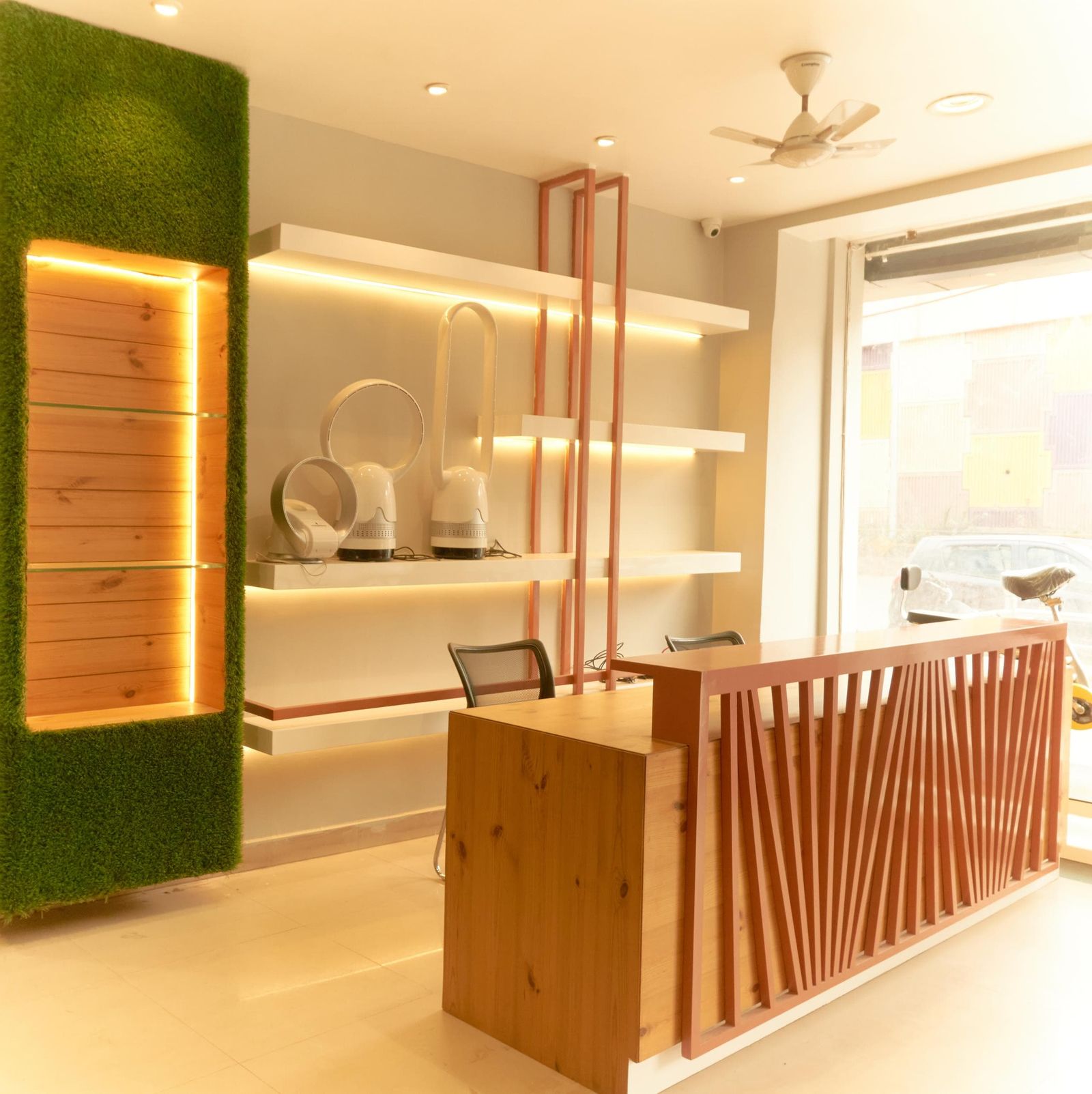 Retail store interior with a moss accent wall and custom display shelving