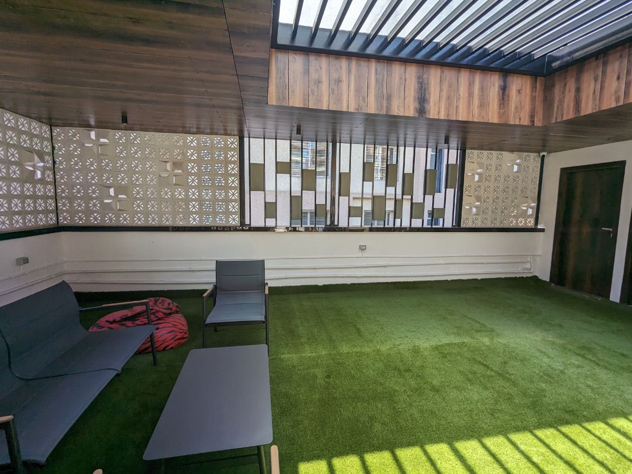 Modern Terrace Lounge with Artificial Turf and Terracotta Screens