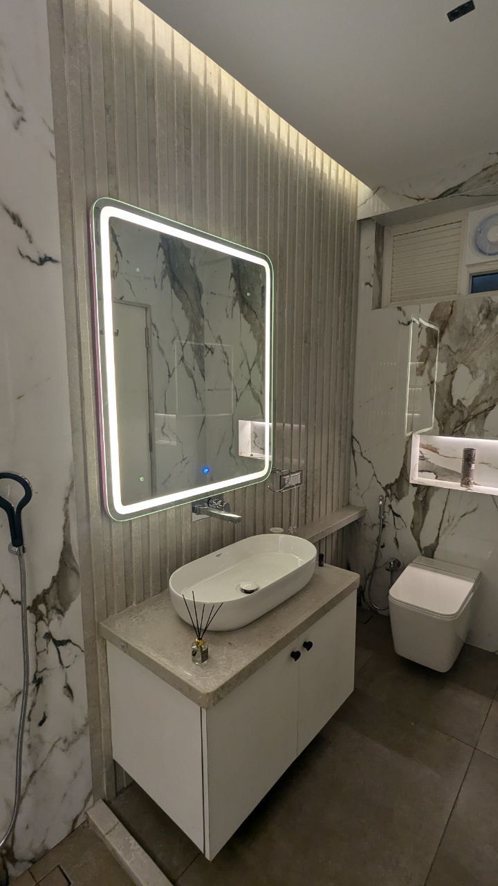 Luxe Bathroom with Backlit Mirror and Marble-Effect Walls